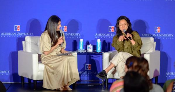 From left: SOC3 faculty advisor Pallavi Damani Kumar and Stephanie Hsu seated on stage against a blue background, speaking.