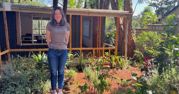 Scarlett Wedergren standing in front of a garden
