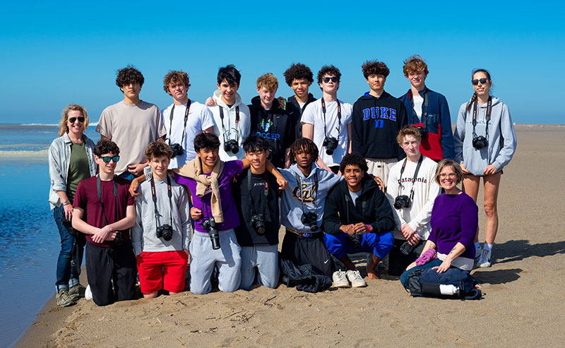 a group of young people by a marsh