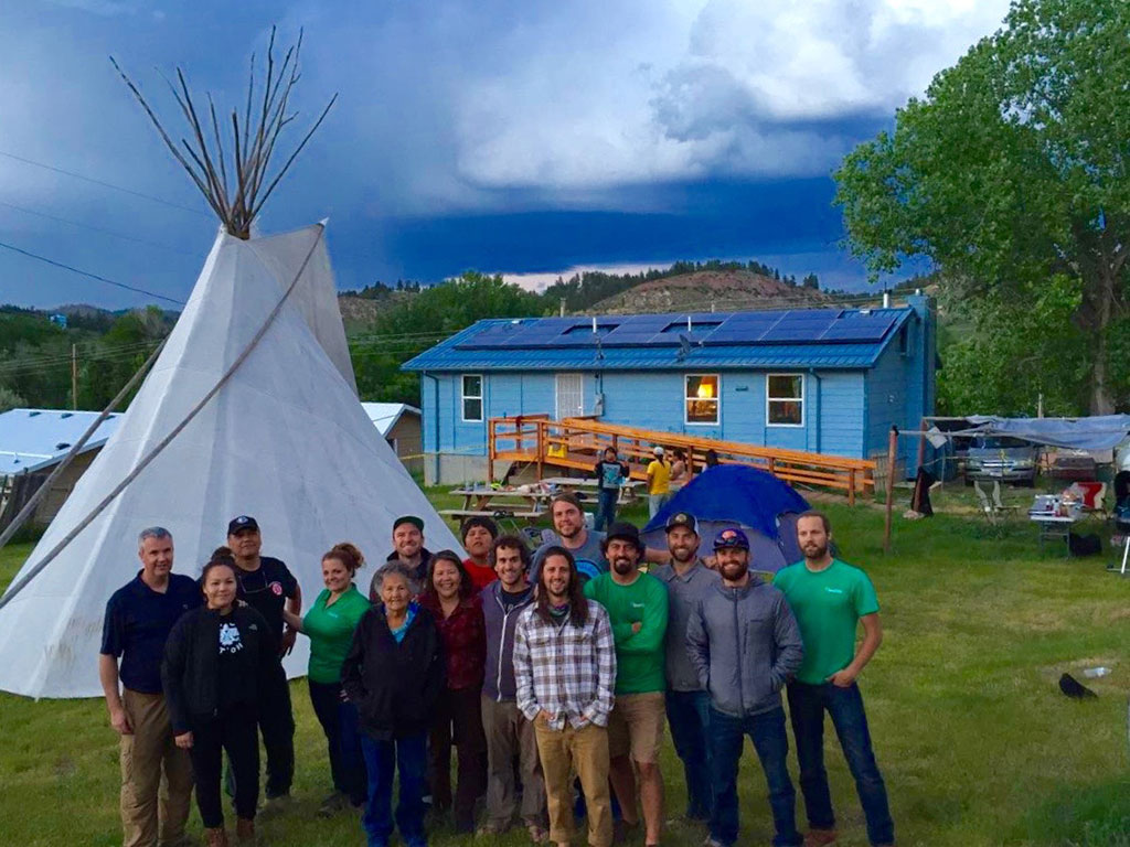 photo of people outdoors, teepee tent nearby