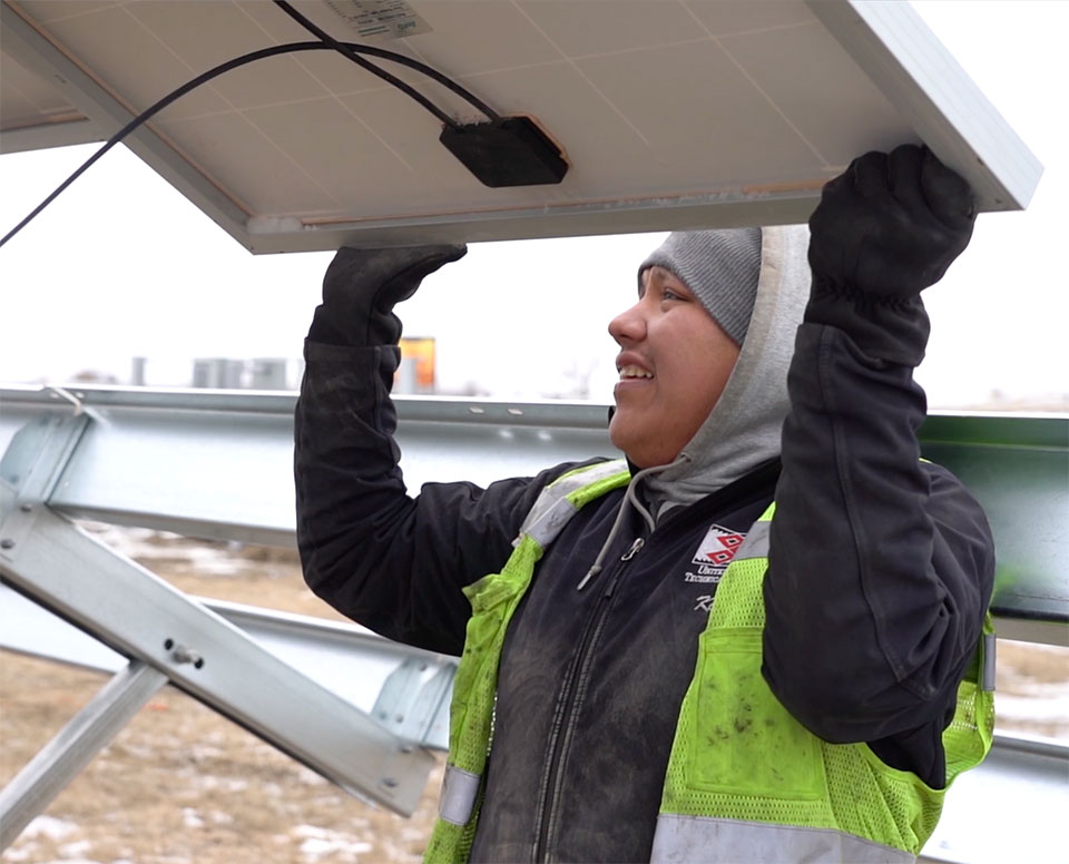photo of a person installing a solar panel