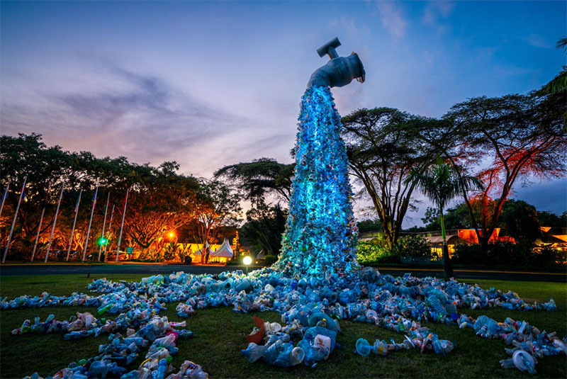sculpture of a faucet spewing plastic waste