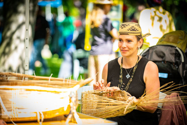 a woman weaving a basket