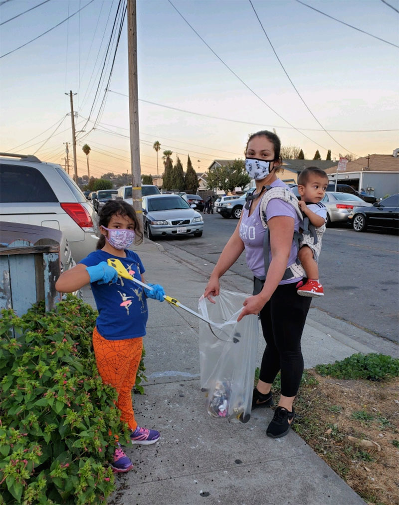 photo of a PPE-masked family collecting litter