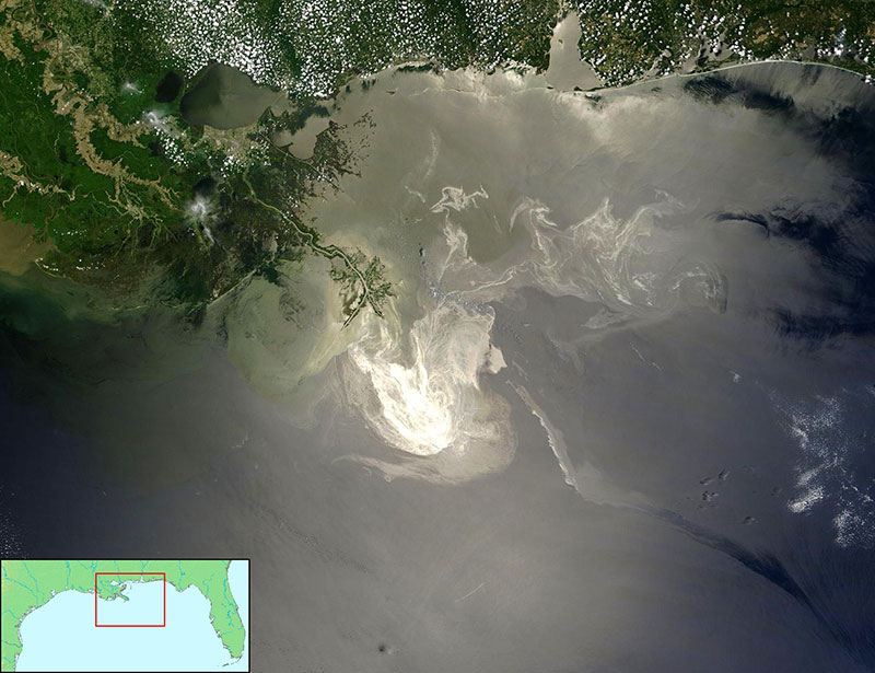 aerial photo of an oilspill-tainted coast, inset map