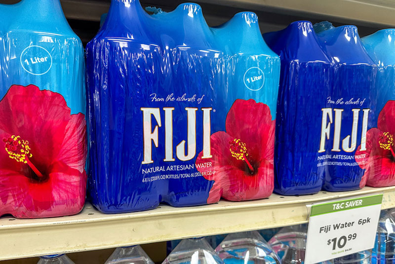 plastic packages of bottled water on a store shelf