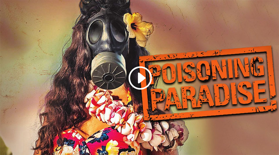movie still depicting a person in Hawaiian clothes and a gas mask