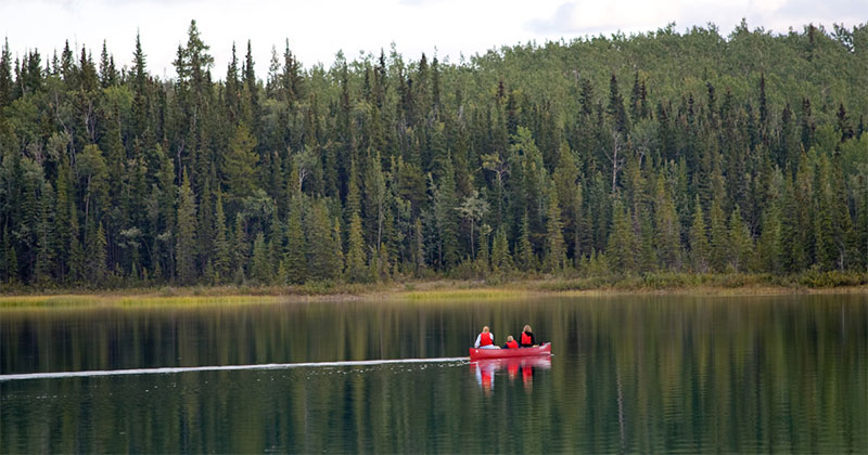 photo of people canoeing in wild lands