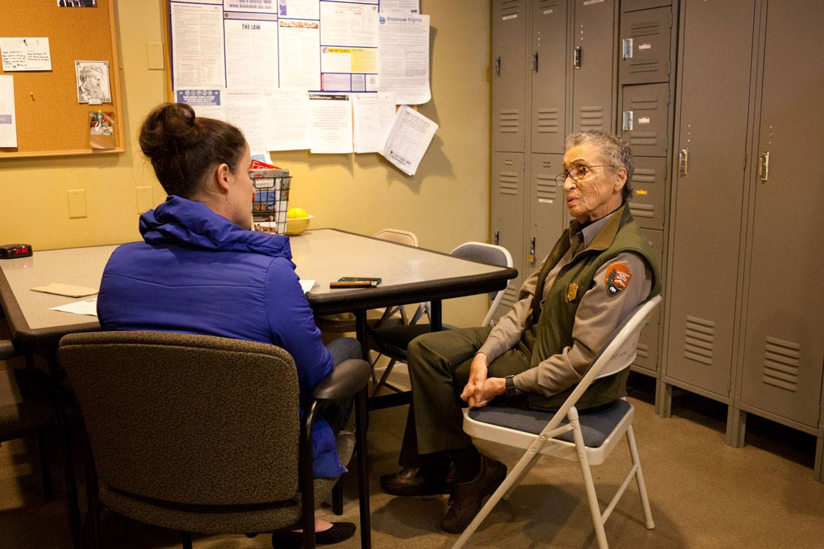 Zoe Loftus-Farren sitting at a table interviewing Betty Reid Soskin, a National Parks Service ranger who retired at age 100 in 2022.