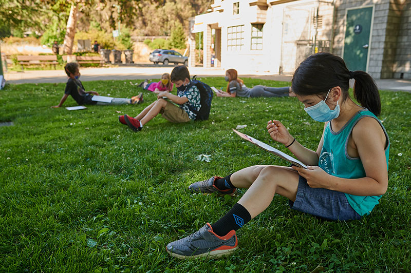 photo of a child reading outdoors