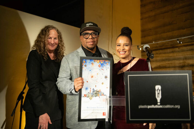 people holding an award, smiling