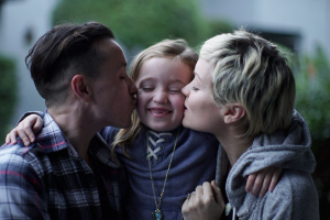 Blue and Emerson kiss their 7-year-old daughter on the cheek in Monterey, California, January 2019.