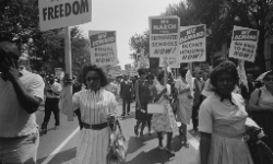 Civil rights advocates carry placards during the March on Washington for Jobs and Freedom on August 28, 1963, in Washington, D.C.