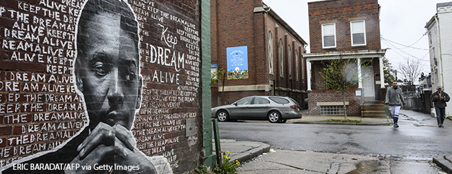 A brick wall mural of Dr. Martin Luther King Jr. 