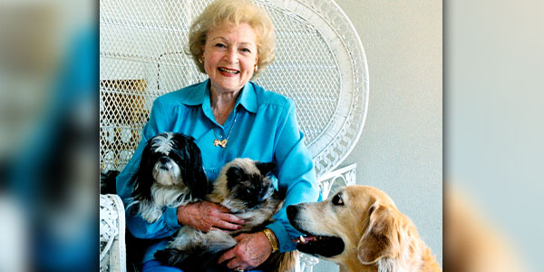 Actress Betty White posing with her 2 pet dogs and 1 pet cat
