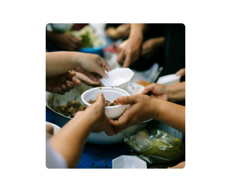 hands passing bowls over a meal