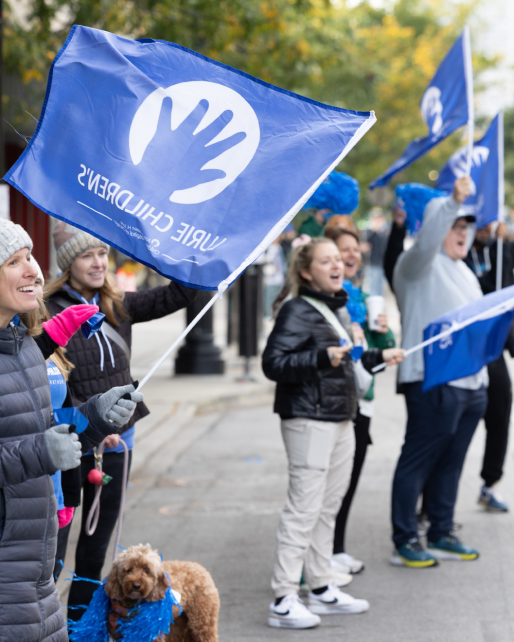 A spectator holding a Lurie Childrens flag