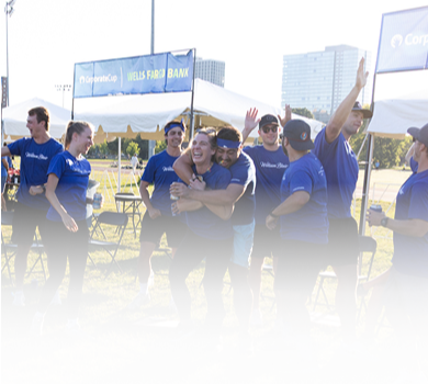 An adult team celebrating a win outside in the sun