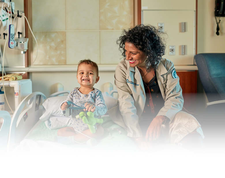 Doctor smiling at baby patient