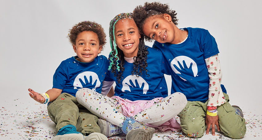 Three children sitting and smiling