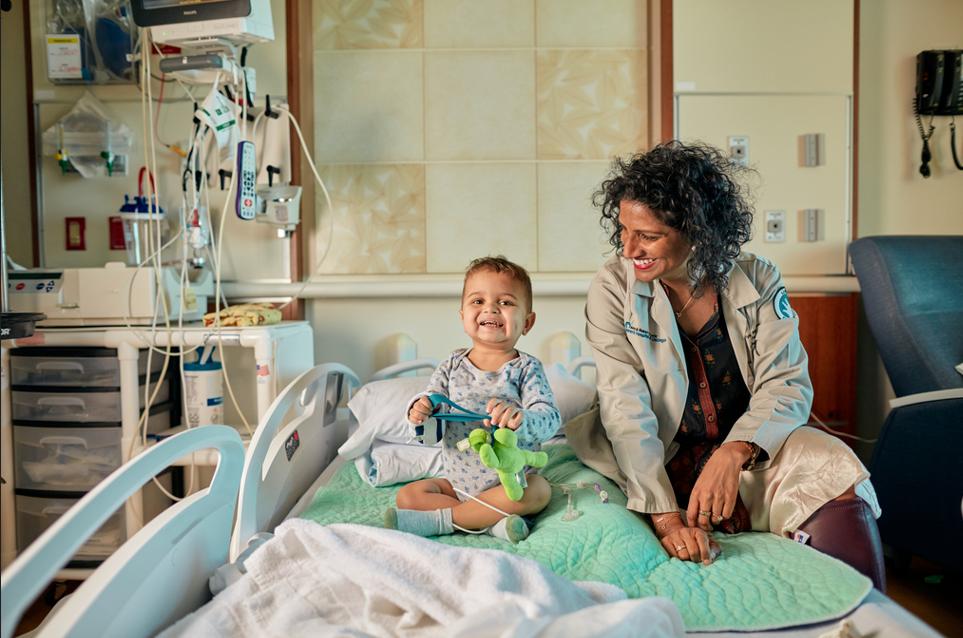 Doctor smiling and looking at child patient