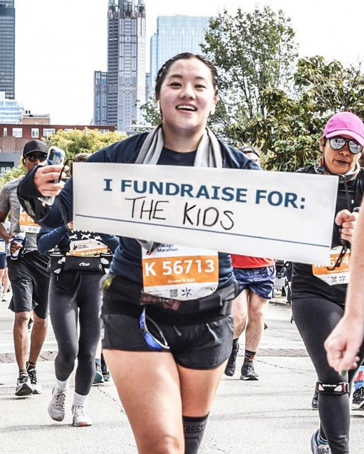 A marathon runner holding a sign.