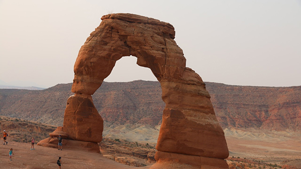 family holding hands on red rocks