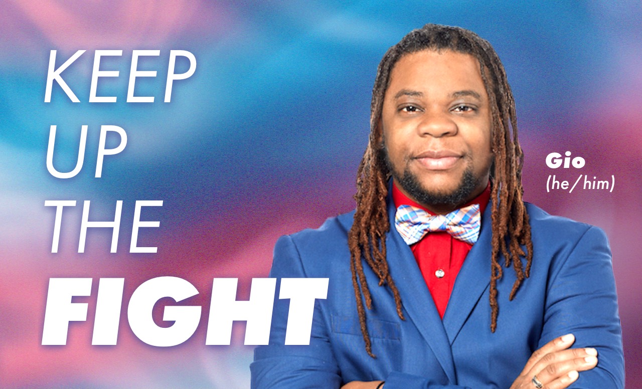 Image of Gio, a black man wearing a blue suit jacket, red shirt, and plaid tie. Next to him is text that reads 'Keep up the fight.'