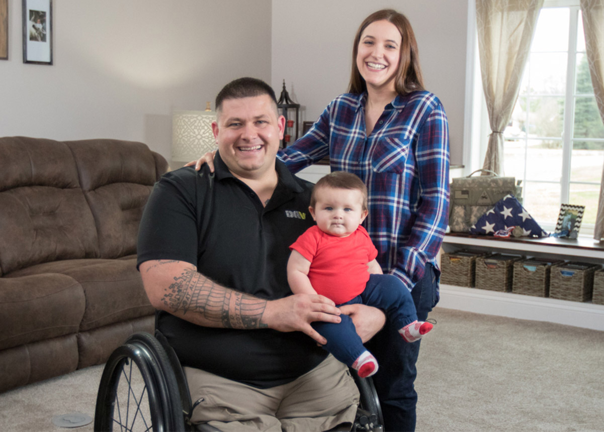 Disabled American Veteran in a wheel chair with wife and child.