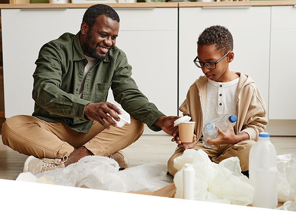 Father and son sorting plastic at home