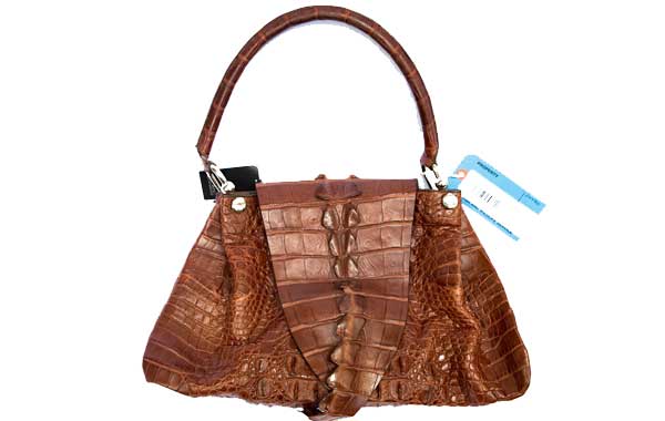 A brown purse has a white and blue tag attached.