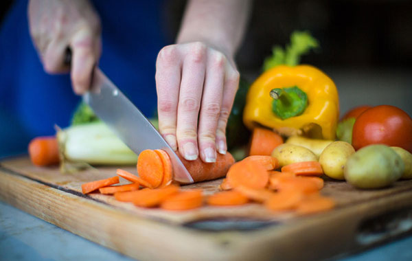 Cutting vegetables on cutting board
