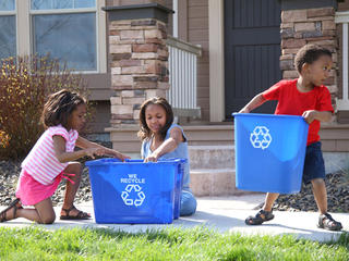 Kids carrying recycling bins