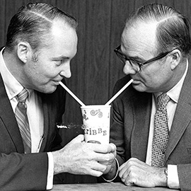 Two men in suits sharing a Fribble