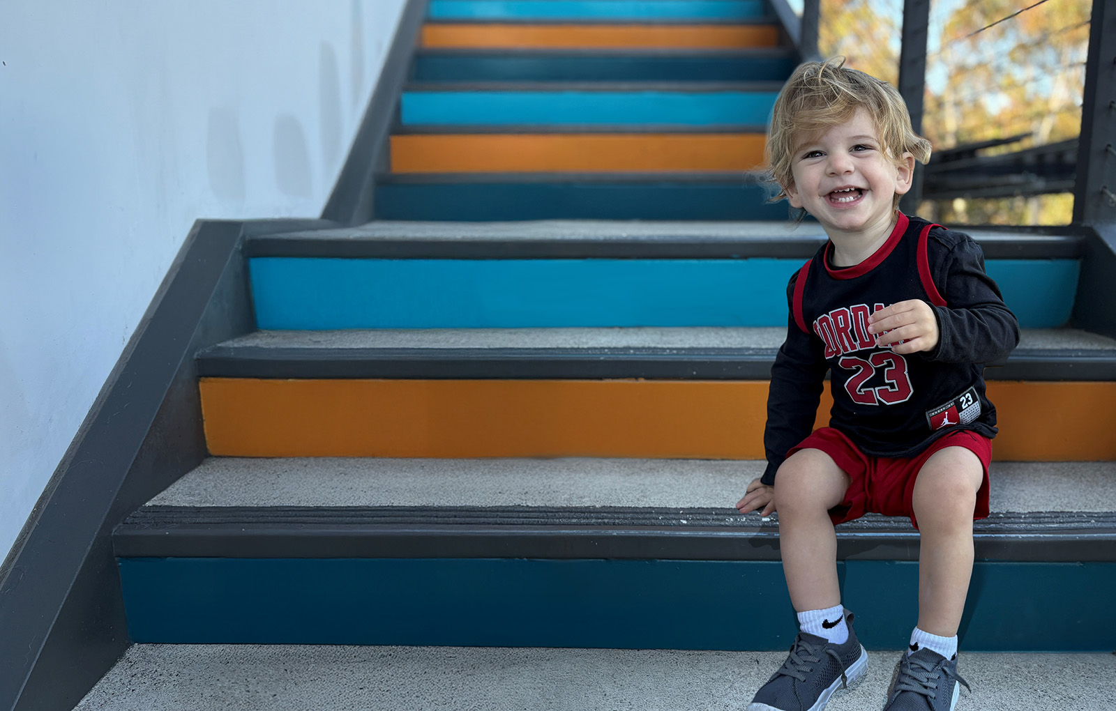 young boy sitting on stairs