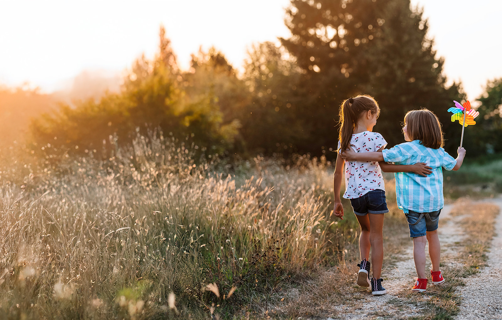 two children walking in a field