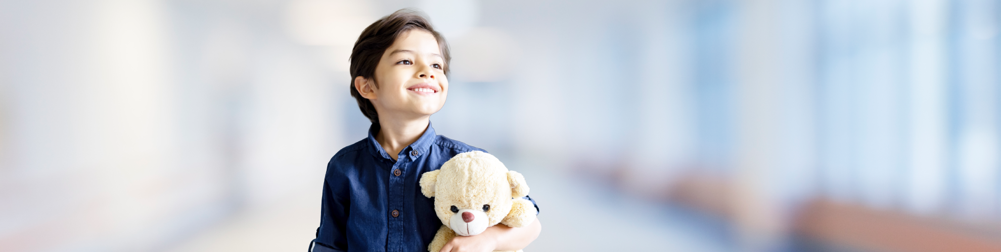 child holding teddy bear