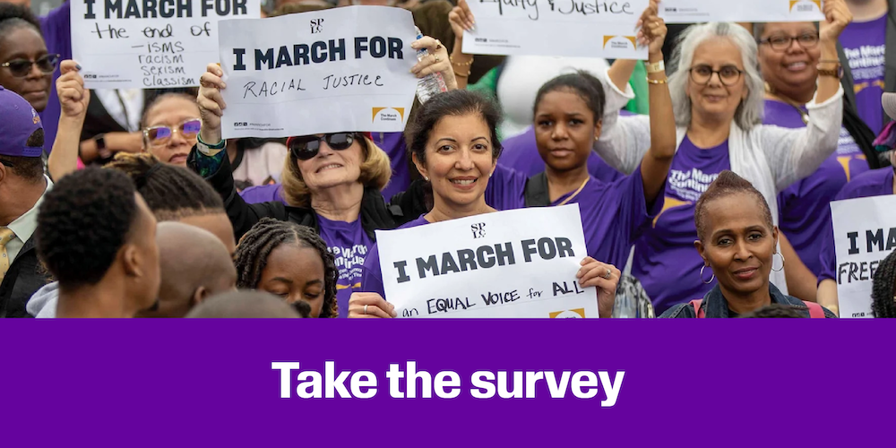 Advocates hold signs. 