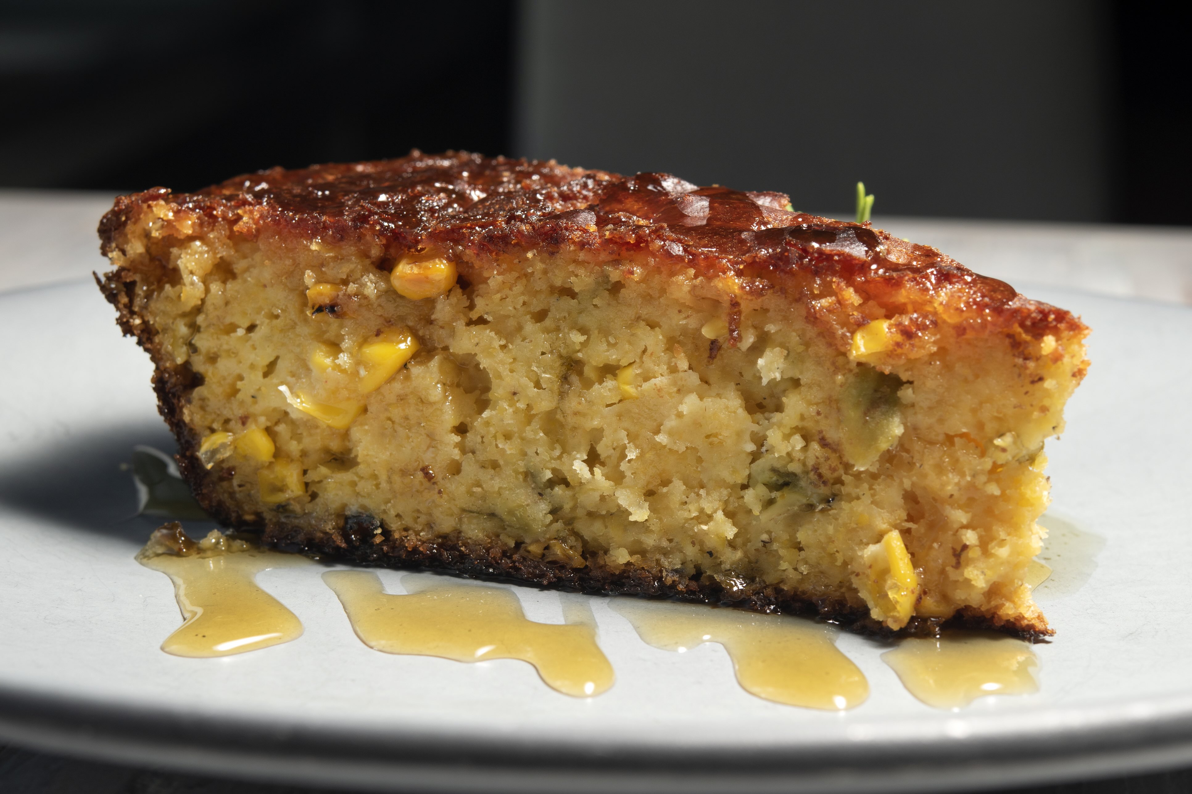 An image of a slice of spicy cheddar cornbread pudding.