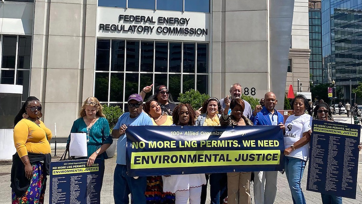 People gathered outside a Federal Energy Regulatory Commission office. They are holding a banner that says: No More LNG Permits. We Need Environmental Justice