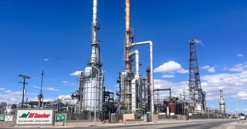 Industrial oil refinery under a bright blue sky in southeastern New Mexico.