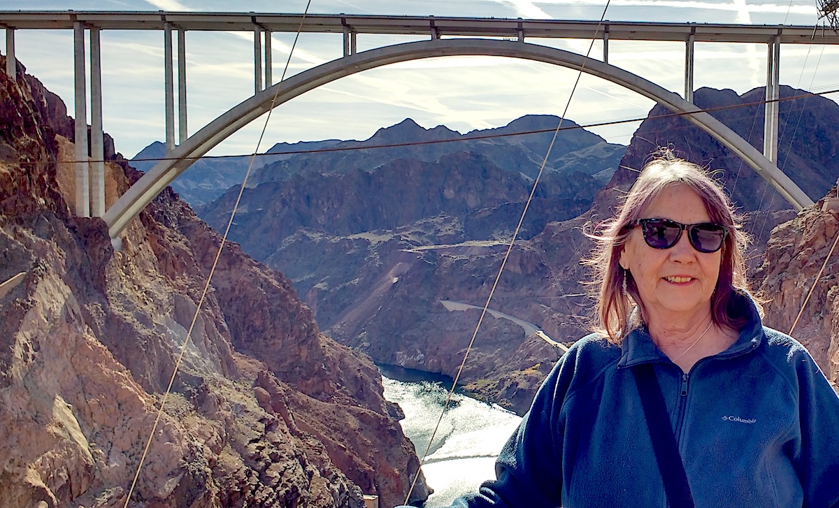 Food & Water Watch volunteer, Jan, with mountains in the background.