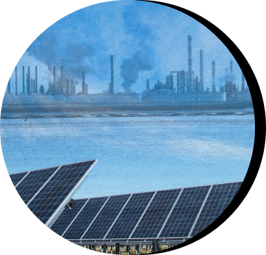 Polluting fossil fuel infrastructure in the background with solar panels in the foreground 