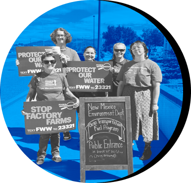 Activists in New Mexico stand together with signs that say Stop Factory Farms