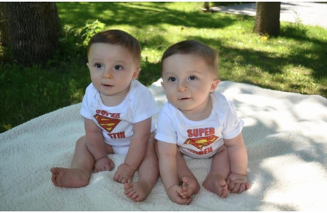 Twin baby boys on a picnic blanket