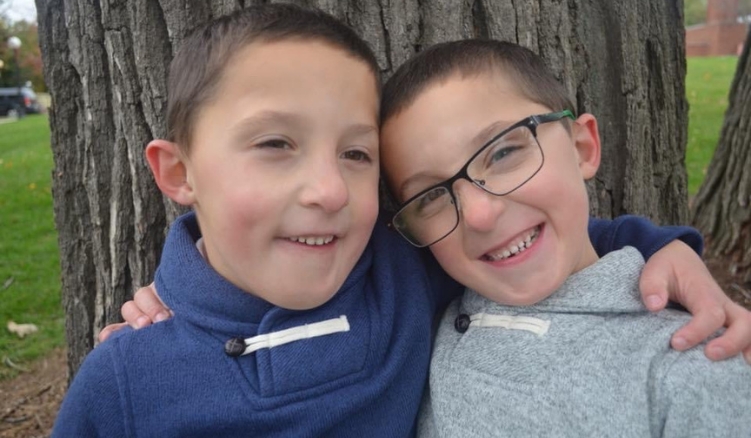 Two twin boys hugging