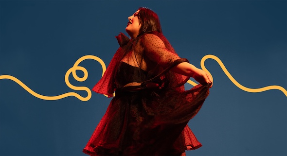 Performer San Cha spins gracefully in a dark red dress.