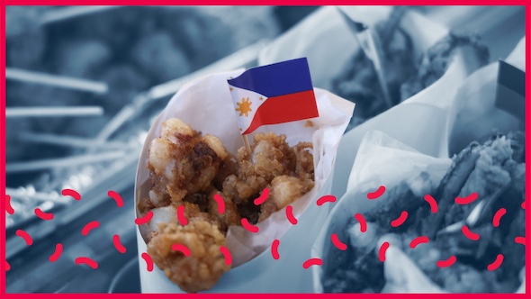 A traditional Filipino snack is wrapped in paper with a miniature Filipino flag peeking out the top.