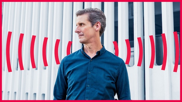 A portrait of Marketplace host Kai Ryssdal in a blue shirt.