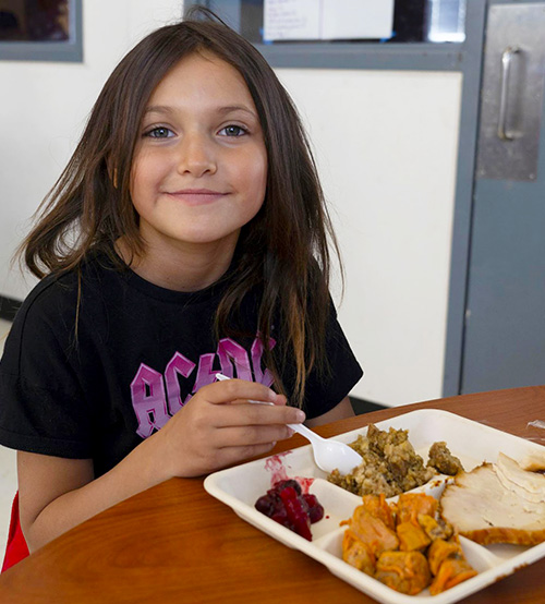 Girl with lunch tray.